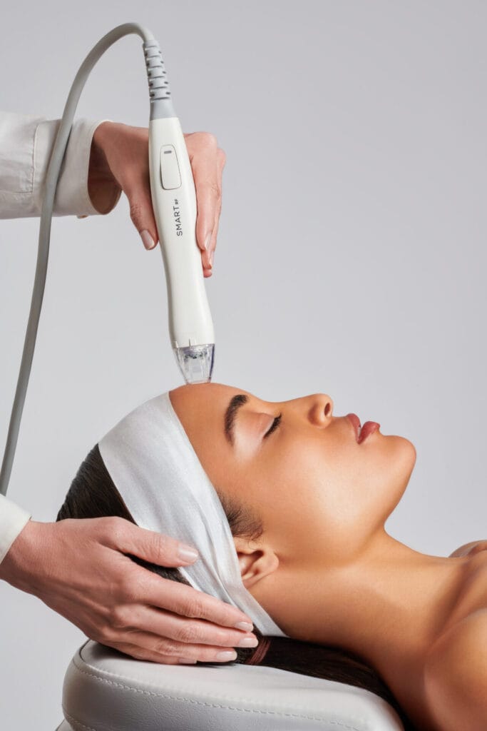 A woman is receiving a facial at a spa.