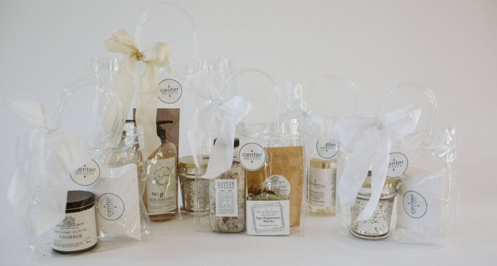 A collection of clear skincare bags filled with various massage items and products for healthy skin.
