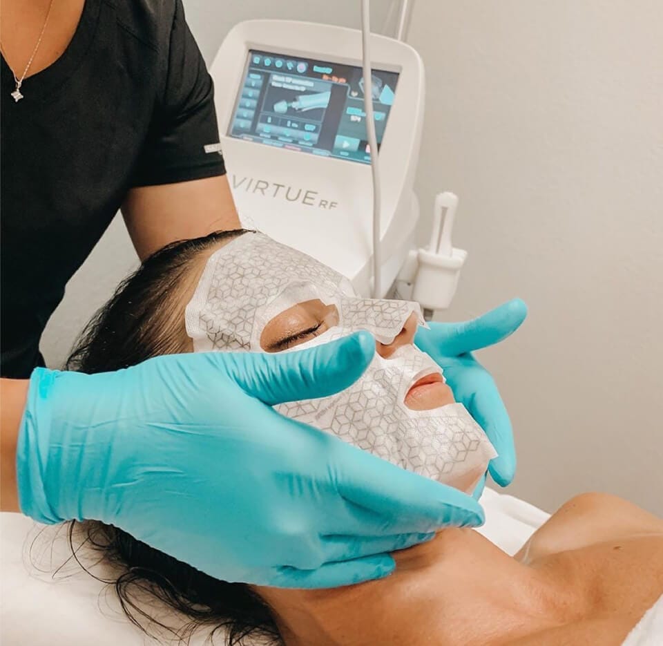 A woman receiving a skin treatment at a spa.