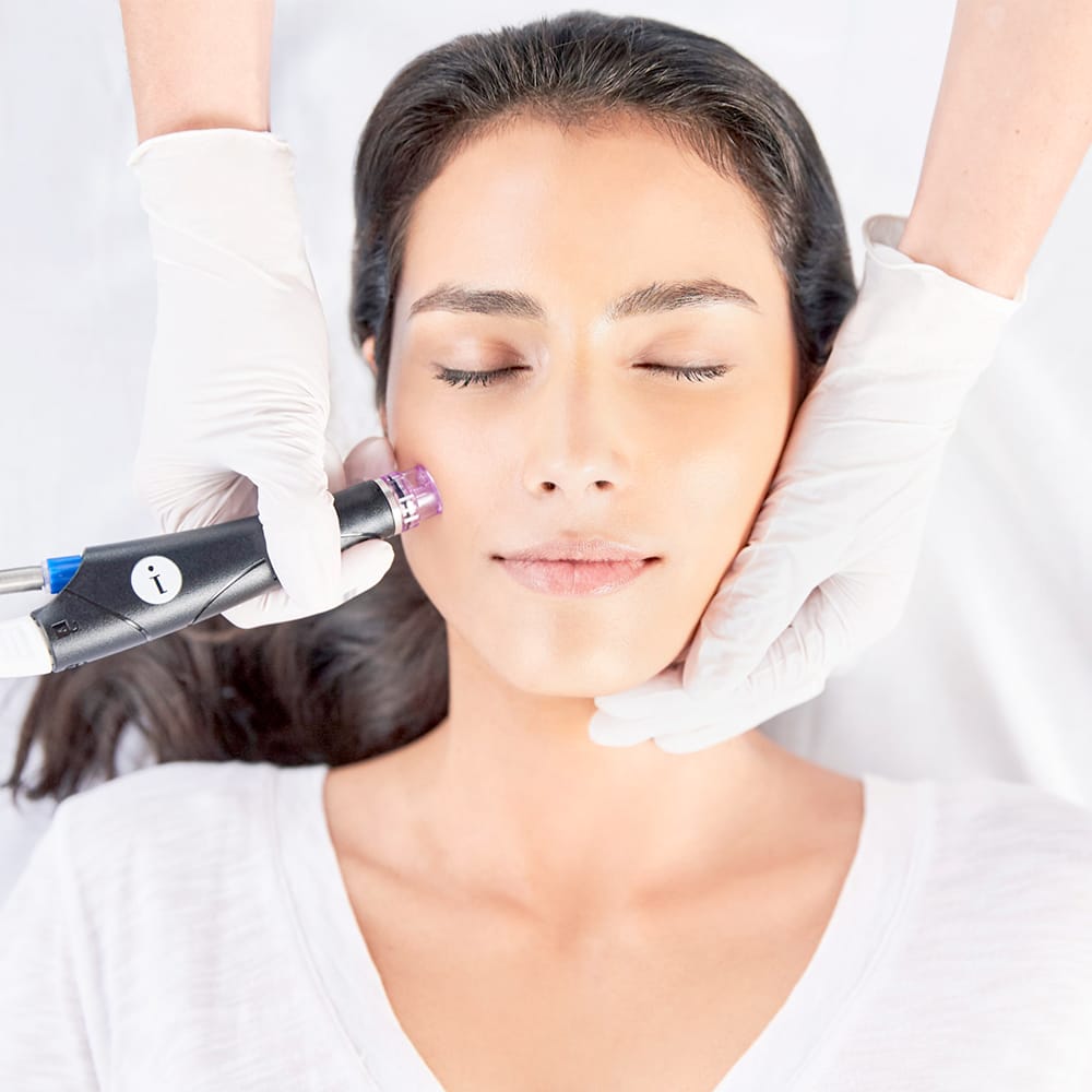 A woman is receiving a rejuvenating facial massage.