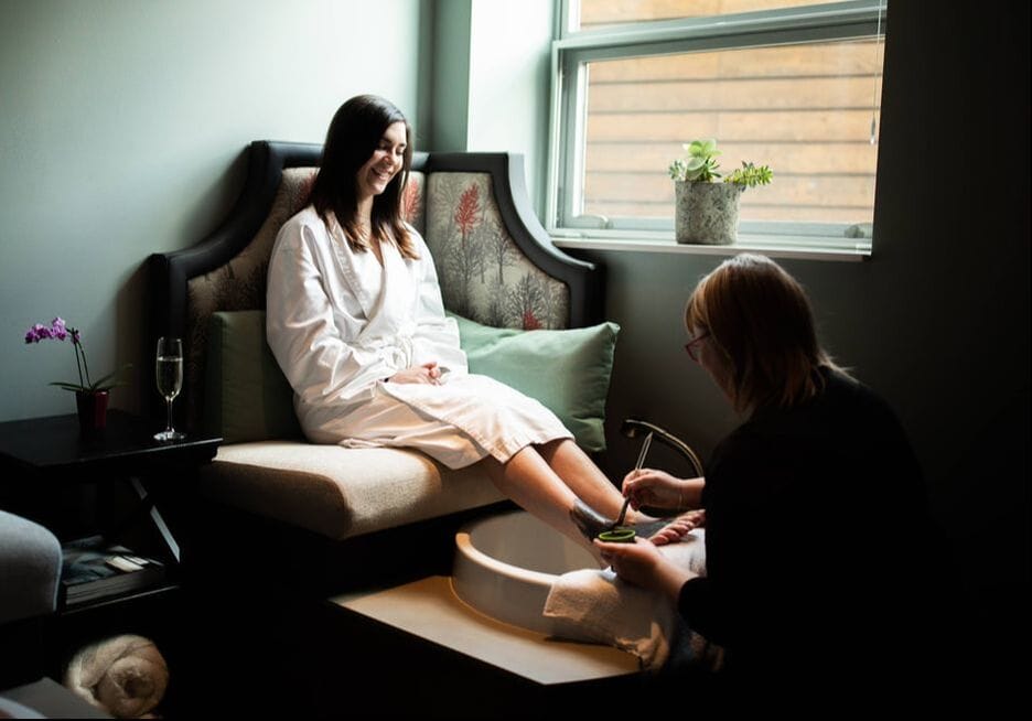 A woman receiving a pedicure at a spa.
