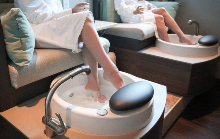 Two individuals indulging in a skincare treatment at a spa.