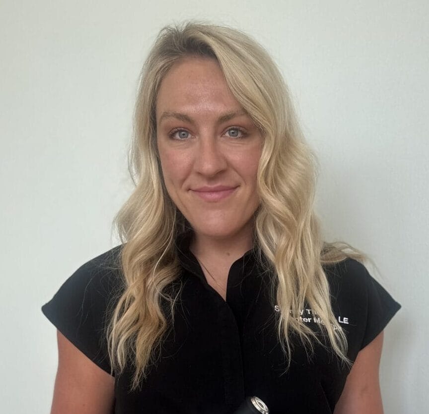 A woman standing in front of a machine in Sydney.