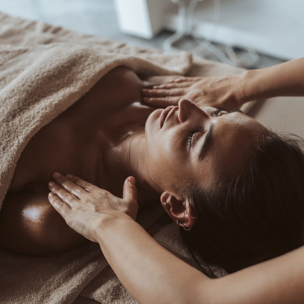 A woman indulging in a relaxing massage for her skincare routine at a spa.