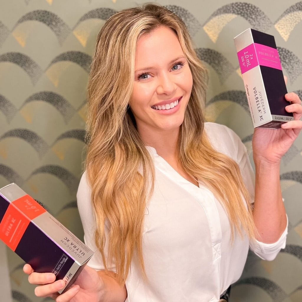 A woman showcasing two boxes of skincare products for hair care.