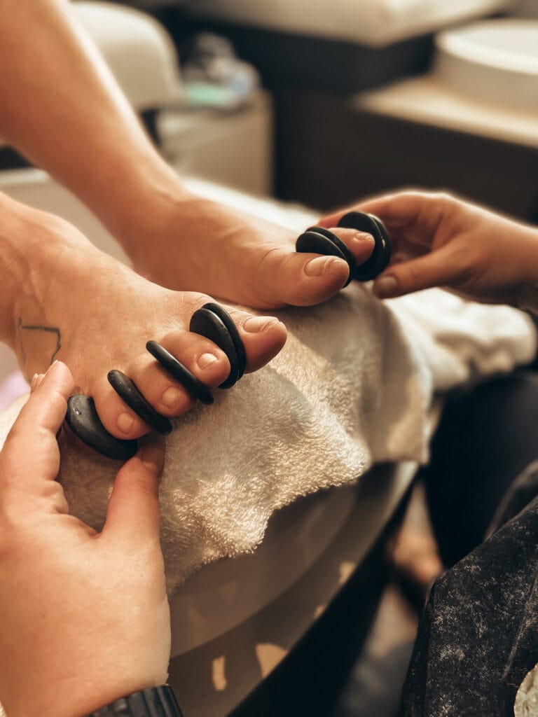 A woman receiving a foot massage at a spa.