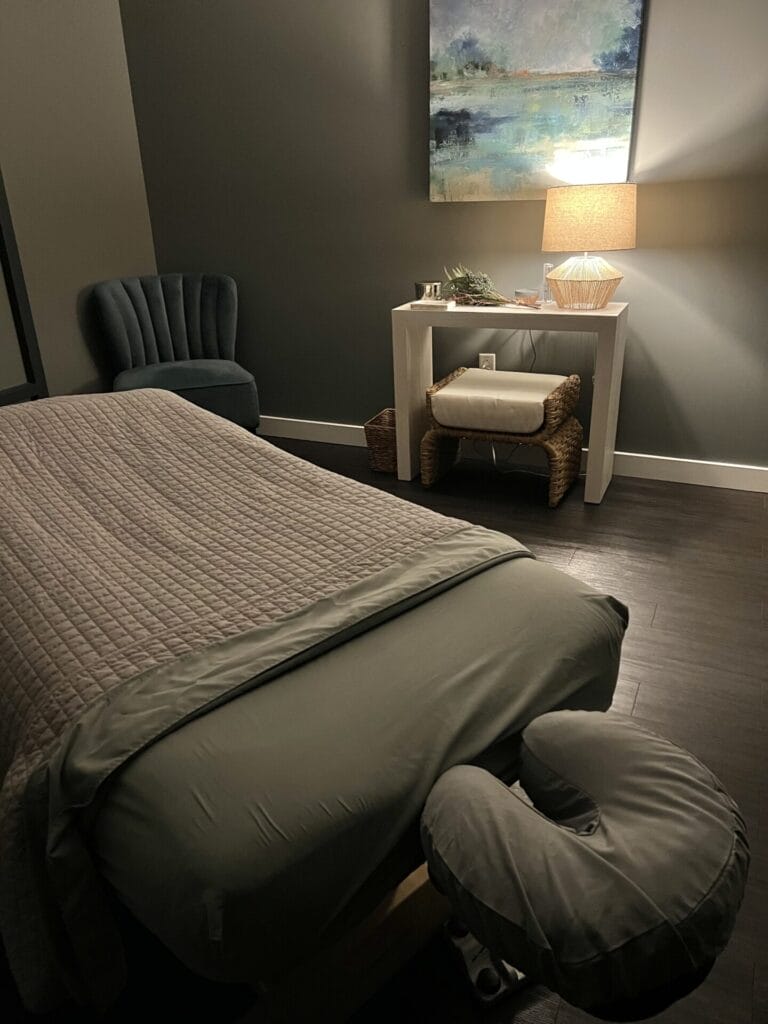 A spa room equipped with a massage bed for skincare treatments.
