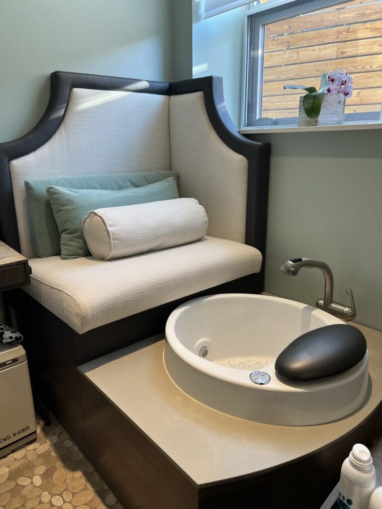 A bathroom with a bathtub for a relaxing bubble bath and a couch for lounging while receiving a facial or massage to pamper and rejuvenate the skin.