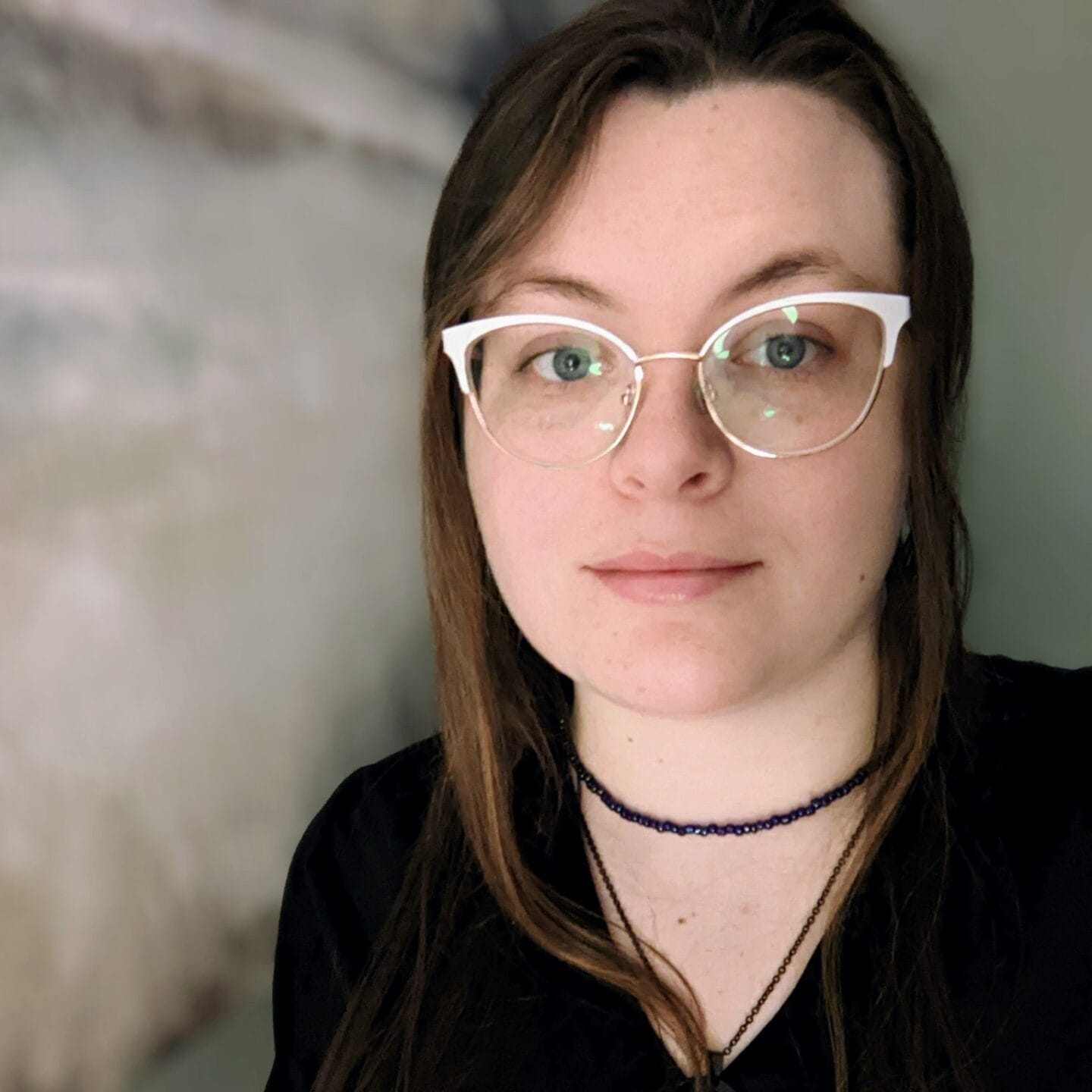 A woman wearing glasses is posing for a photo at a spa.