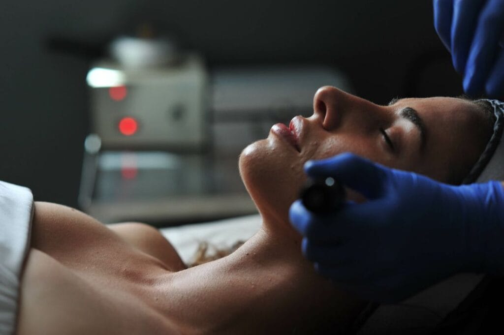 A woman receiving a skincare treatment at a spa.