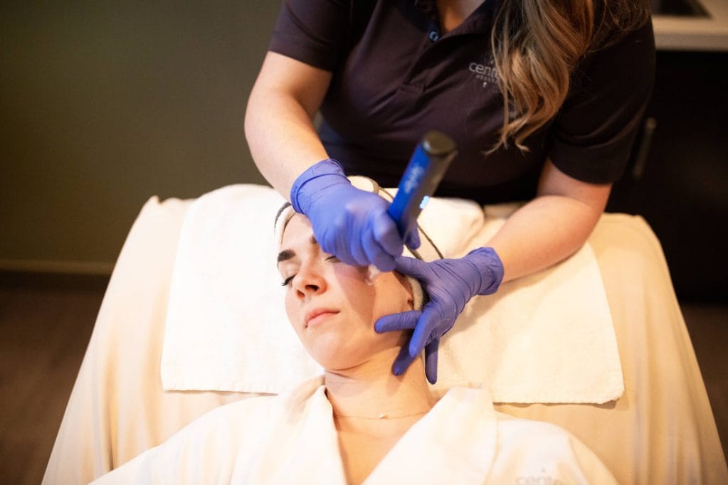 A woman receiving a rejuvenating skincare treatment at a spa.