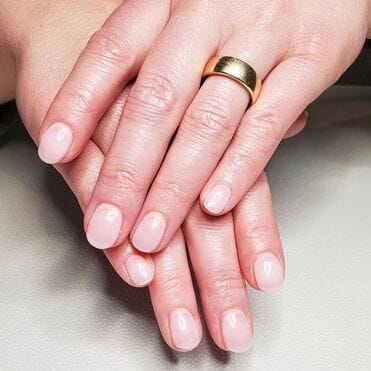 A woman's hands with pink nails offering skin and massage treatments.