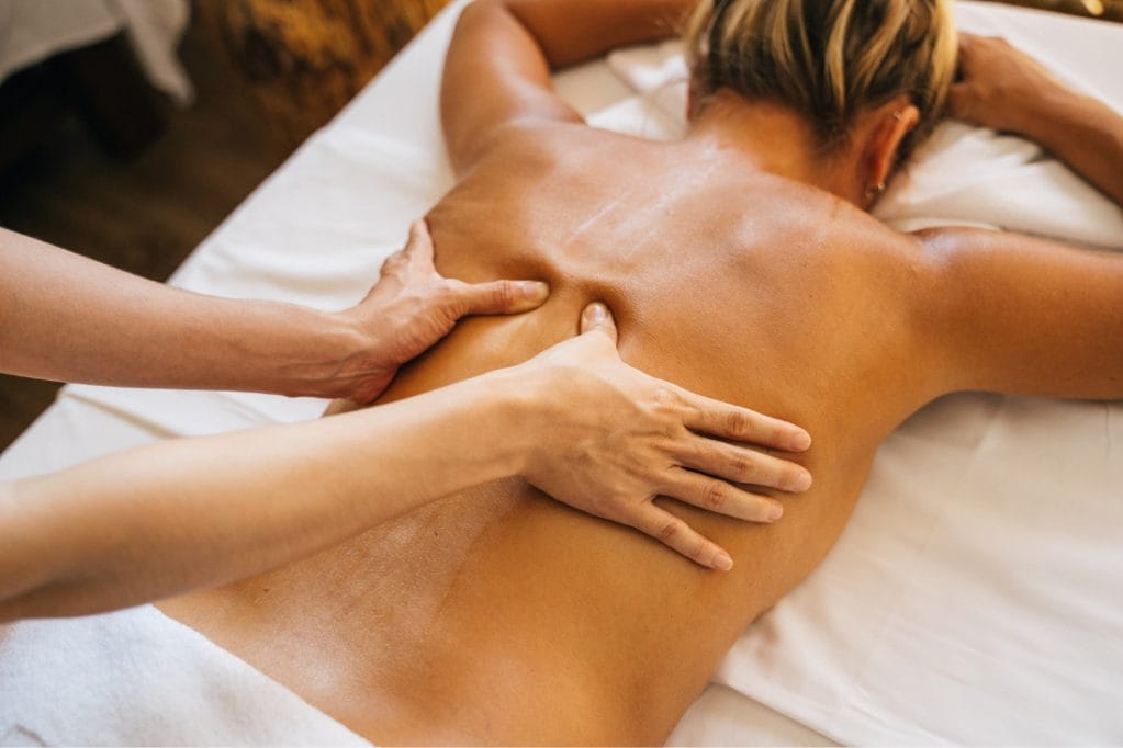 A woman receiving a relaxing back massage at a spa.