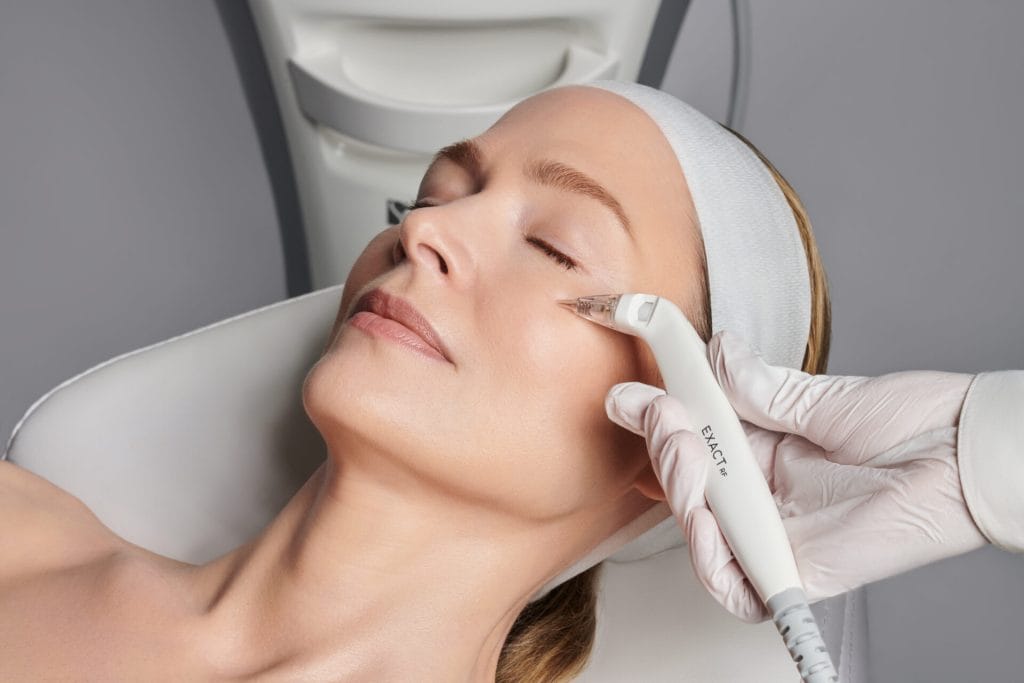 A woman receiving spa skincare treatment at a beauty salon.