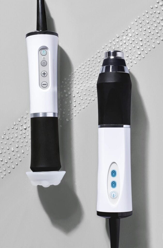 A black electric hair trimmer on a gray surface.