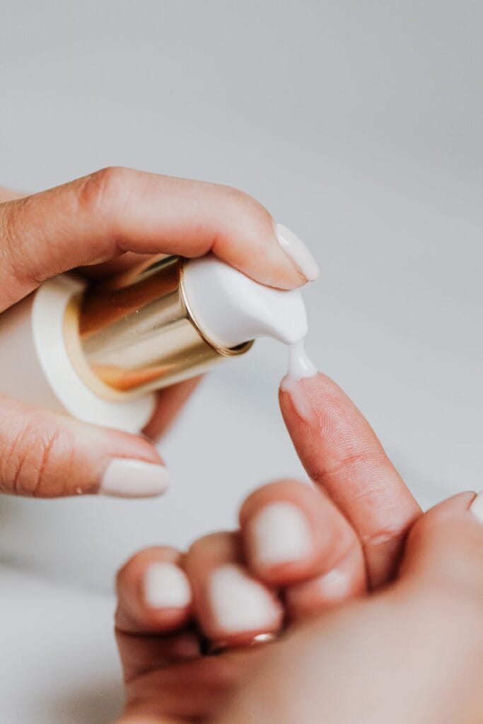 A woman performing a spa skincare routine on her nails.