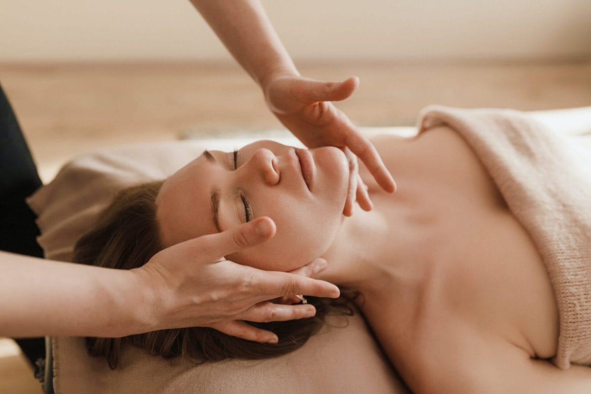 An woman receiving a relaxing lymphatic drainage massage at a spa.