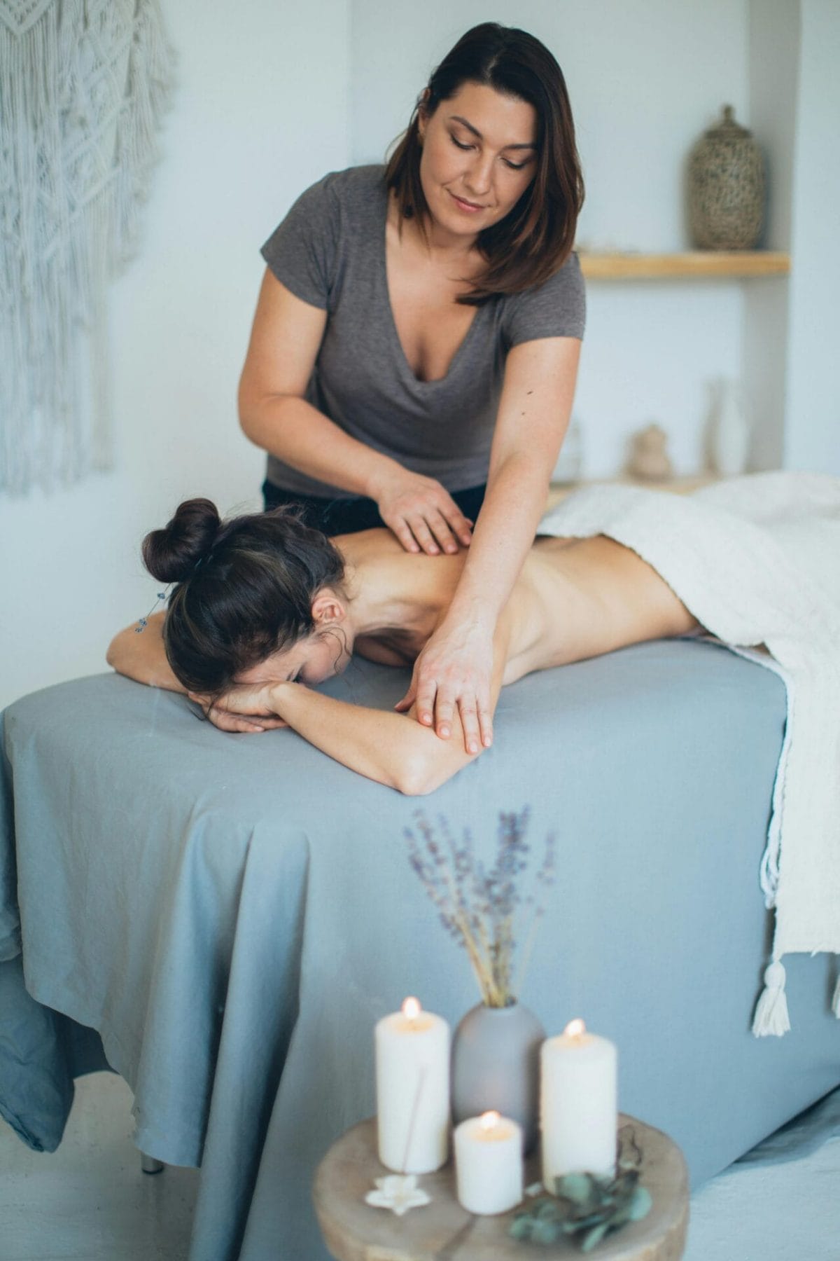 A woman receiving lymphatic drainage massage in a spa.